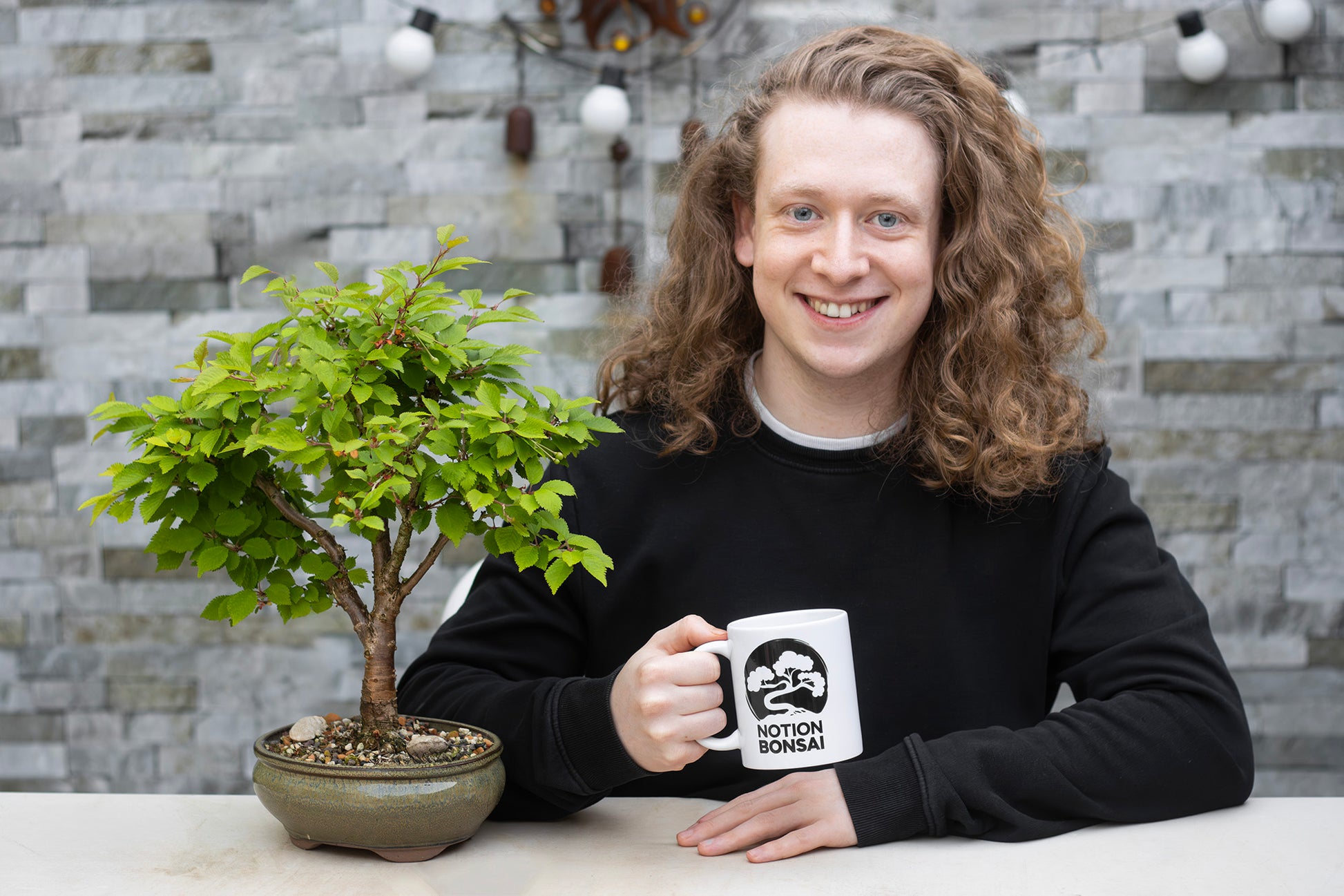Notion Bonsai Mug Cup merch Adam holding