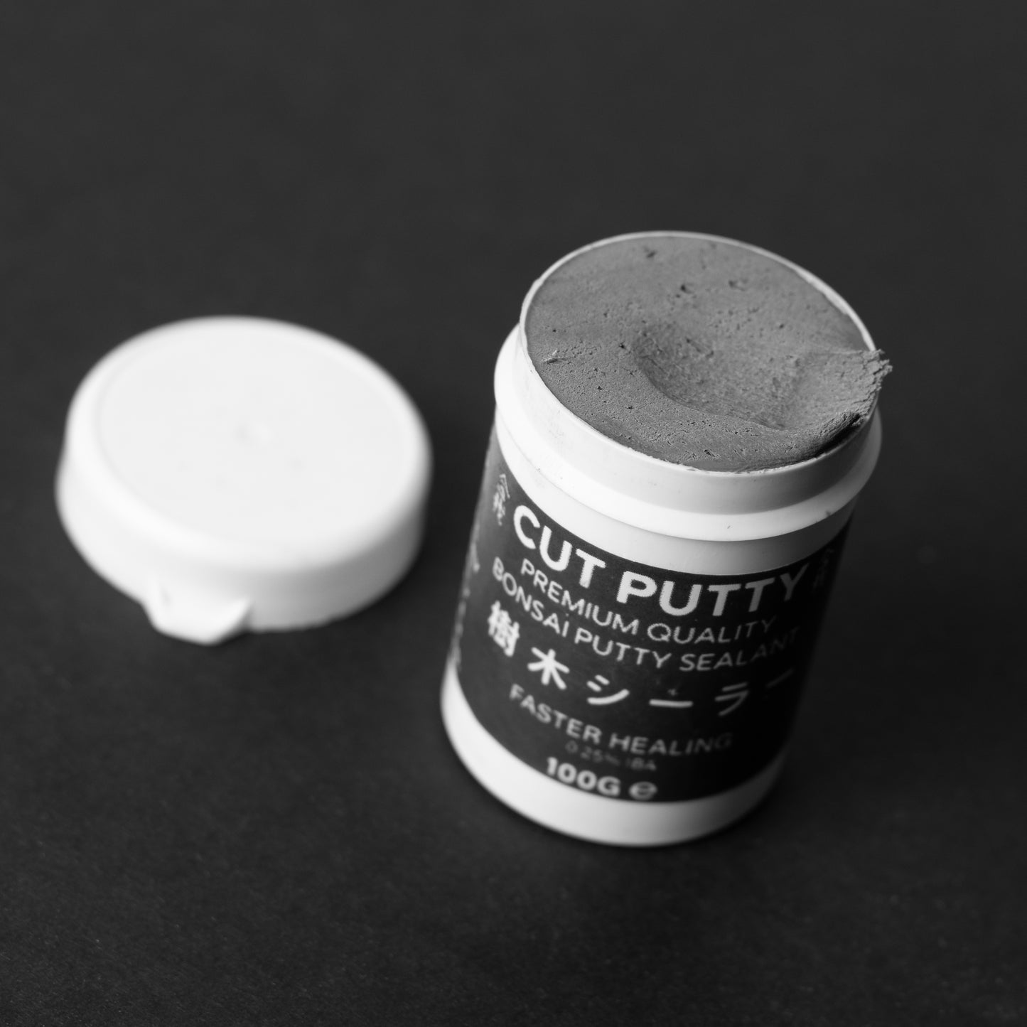 Bonsai Cut Putty, Cut Paste, Grey and Brown Colored, Inside the Grey Tub showing colour of putty